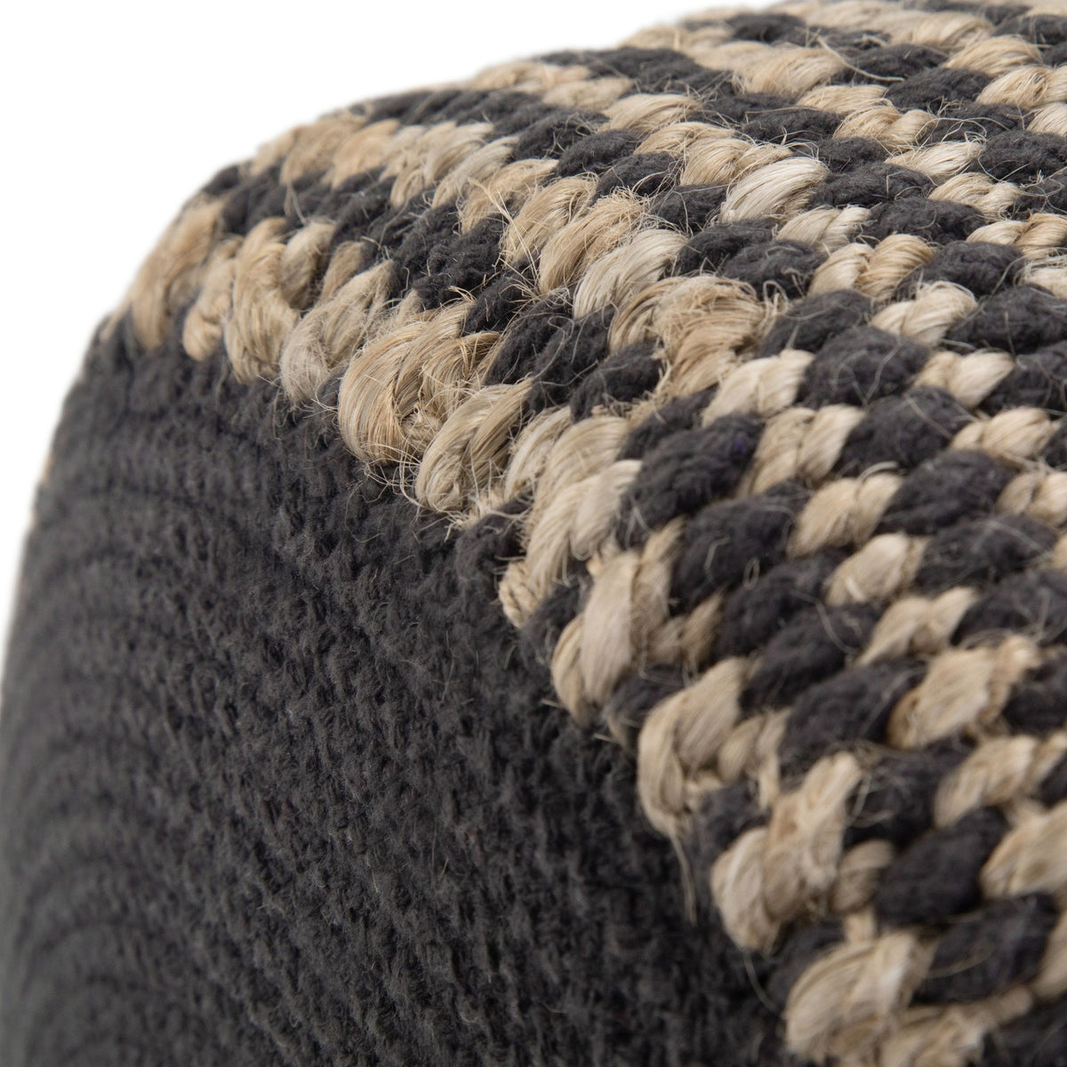 Close-up of dark and beige braided rope-knit pouf texture with rounded edge