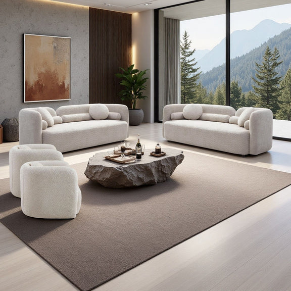 Light beige fabric sofa set with curved arms and two small accent chairs