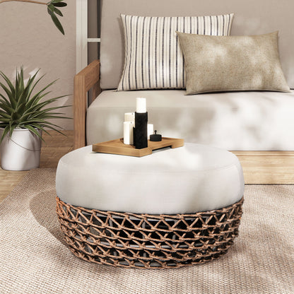 Round light beige patio ottoman with upholstered top and dark wicker woven base