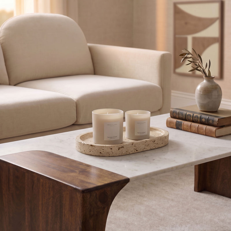 Beige round travertine tray with two candles on recessed surface