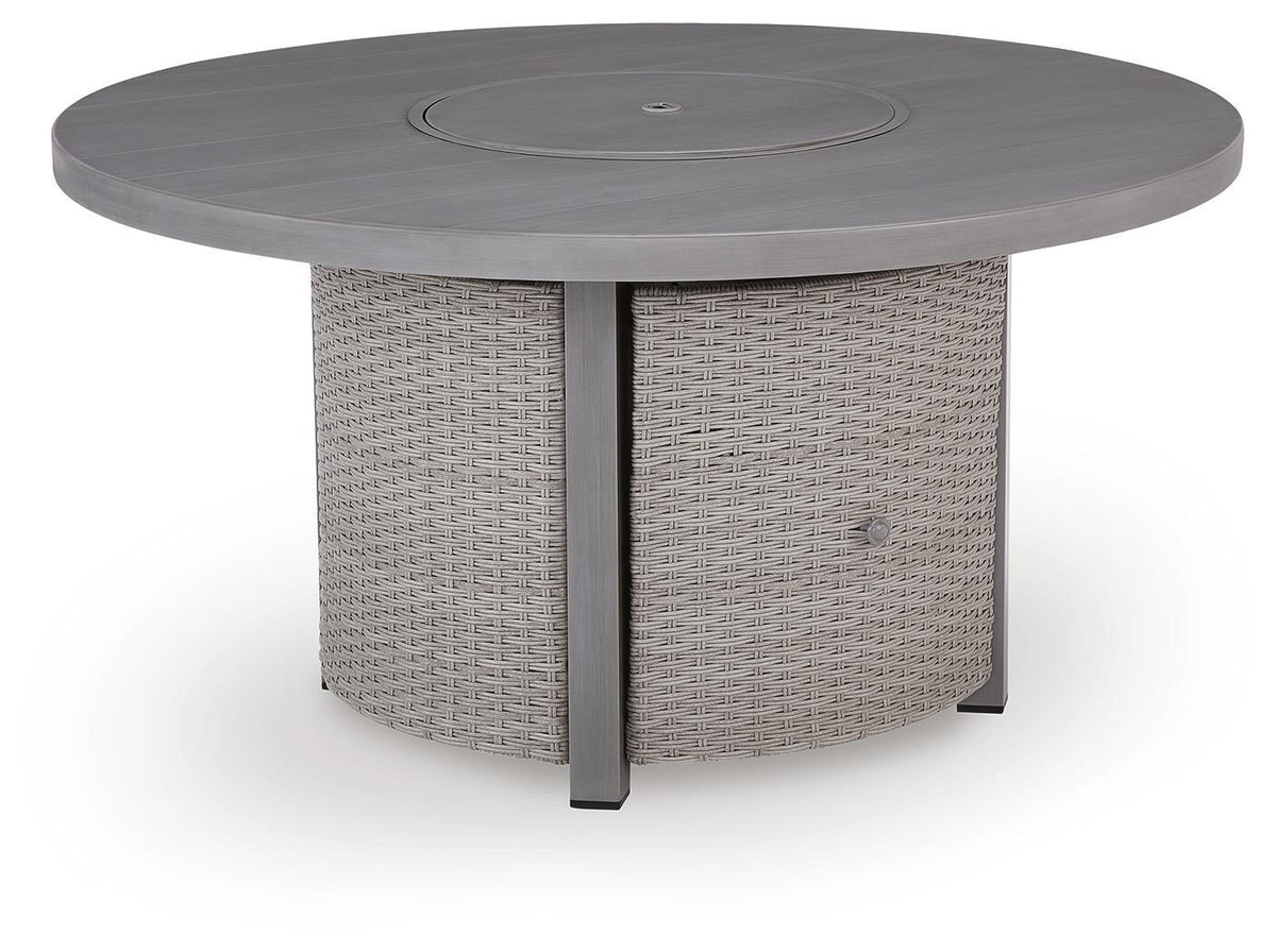 Gray round fire pit table with circular top panel and woven cabinet sides, angled view