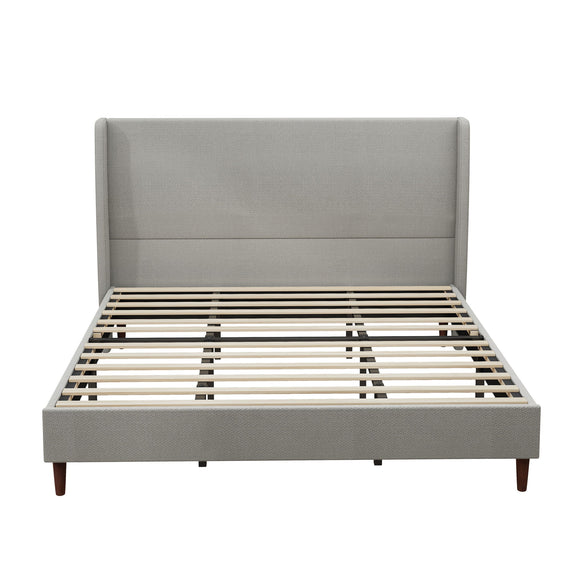 Gray upholstered bed frame with tall headboard, slats, and tapered legs