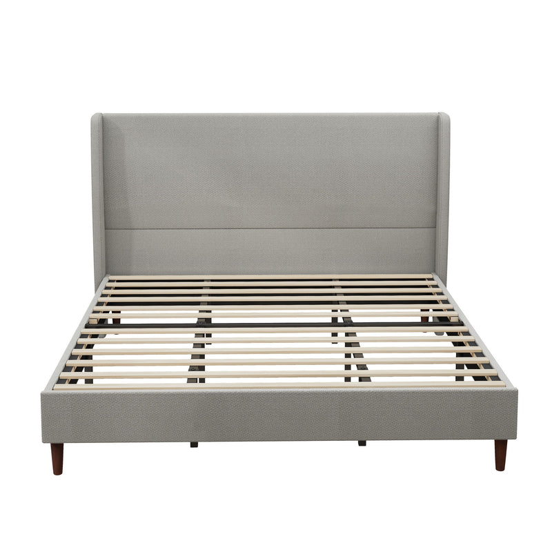 Gray upholstered bed frame with tall headboard, slats, and tapered legs