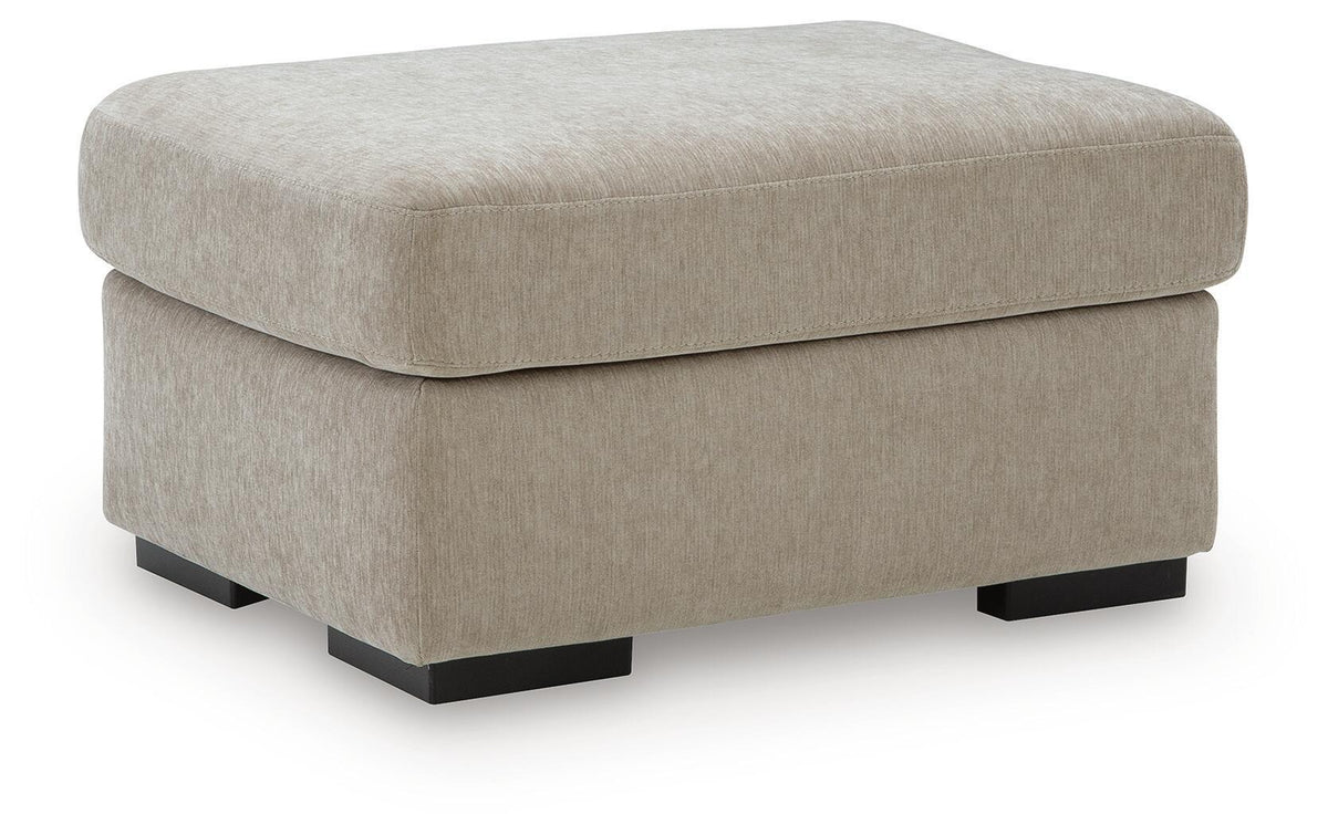 Light brown fabric ottoman with rounded lid and dark tapered legs