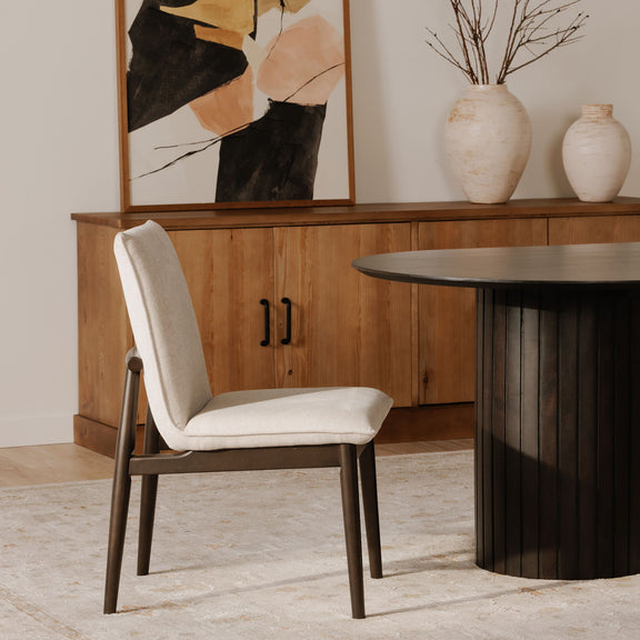 Beige dining chair with dark wooden frame, curved armrests and padded seat