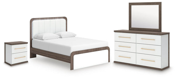 White upholstered bed with dark frame, dresser with mirror, and matching nightstand