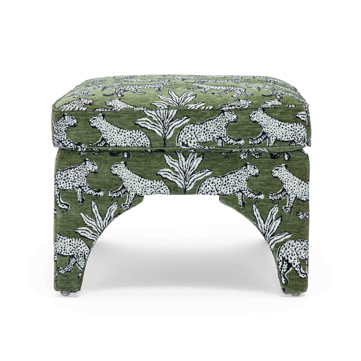 Upholstered ottoman in dark green with white jungle animal print, round padded top, arched legs