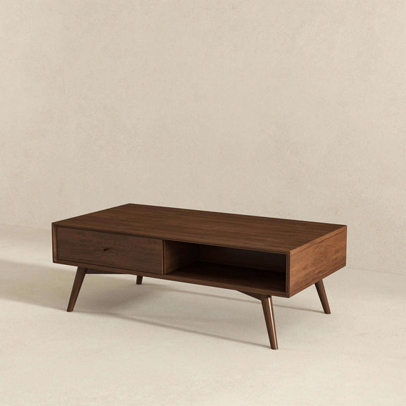 Walnut brown coffee table shown at an angle, with a drawer and open shelf