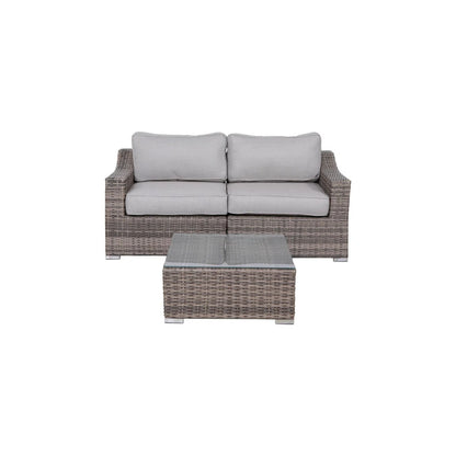 Outdoor wicker conversation set with two-seat sofa, grey cushions, and rectangular coffee table