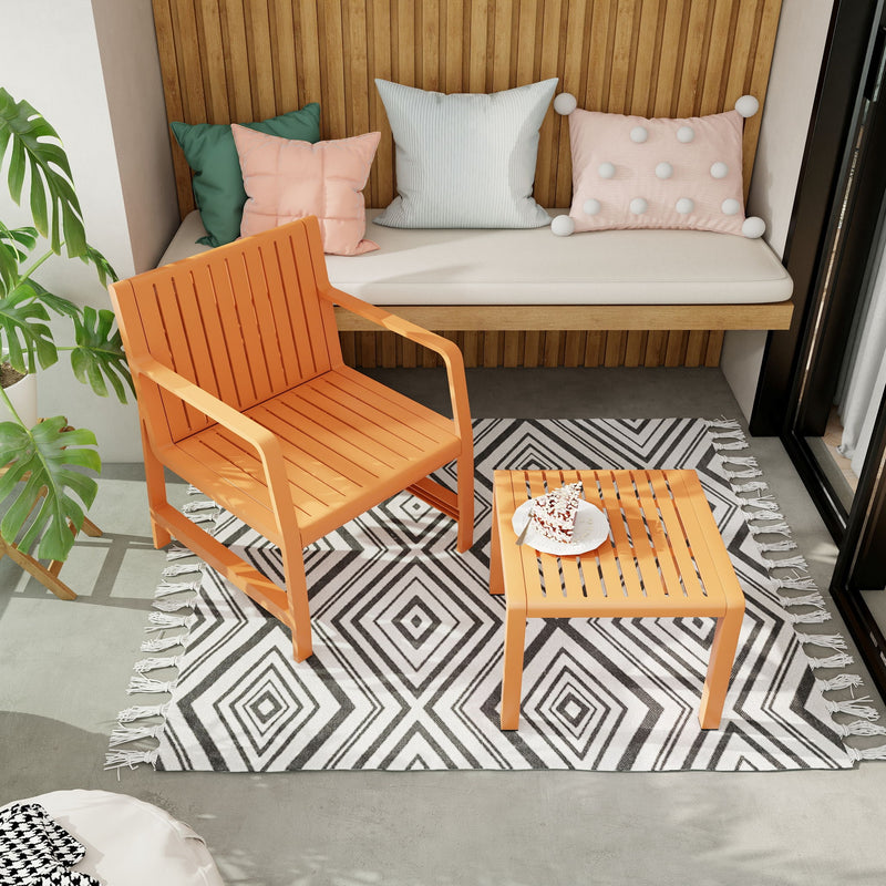 Orange outdoor armchair with slatted side table, on patterned rug