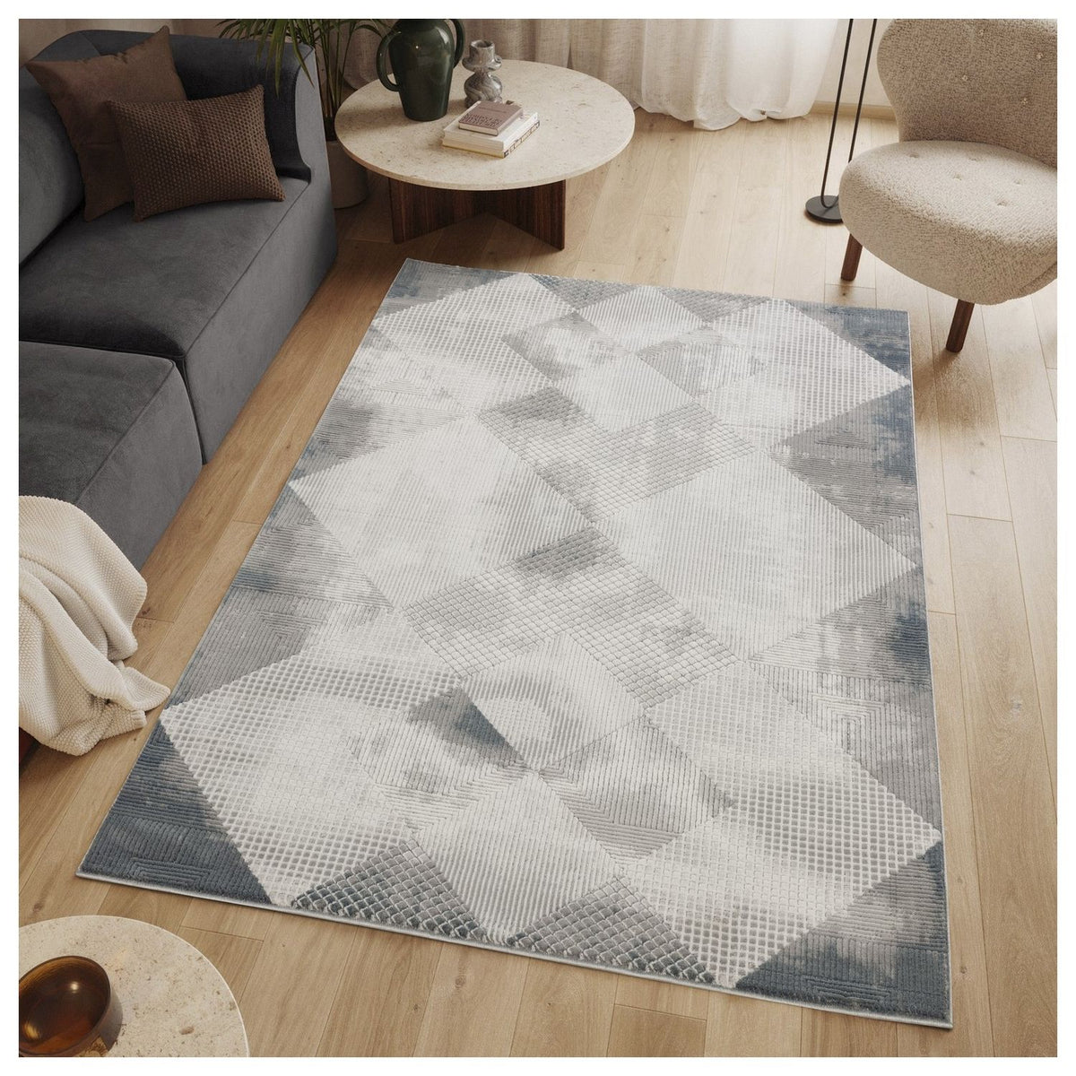 Gray geometric area rug with diamond pattern on a wood floor