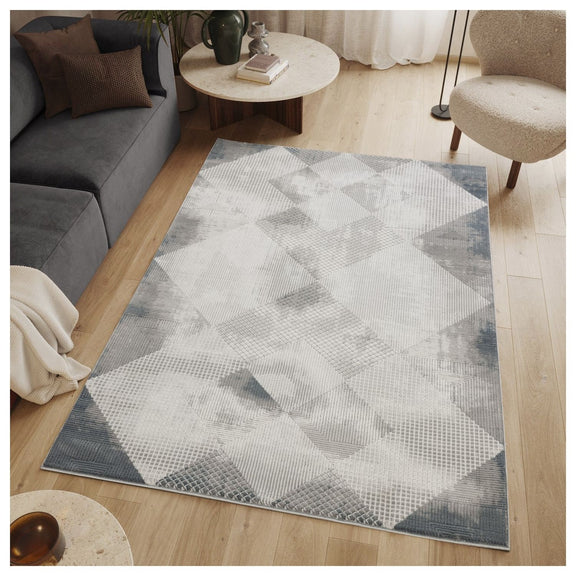 Gray geometric area rug with diamond pattern on a wood floor