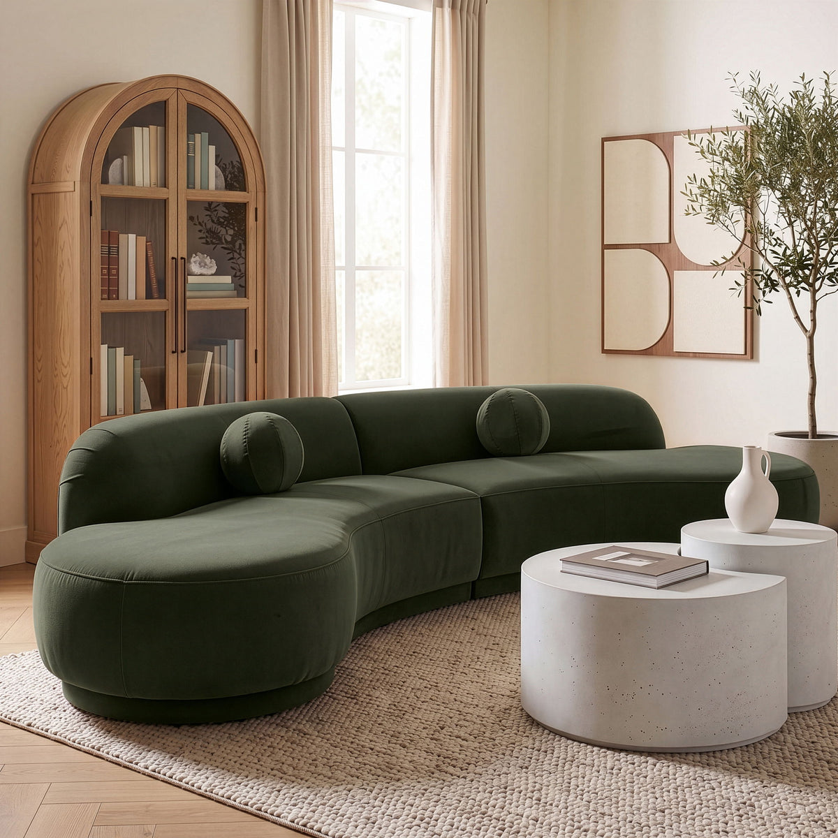 Dark green velvet sectional sofa with rounded arms and multiple accent bolsters
