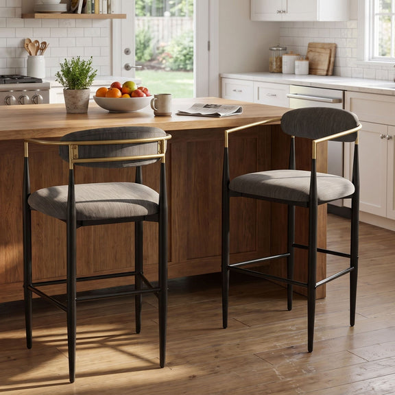 Pair of charcoal bar stools with padded seats, curved backs and black metal frames with gold-tone accents