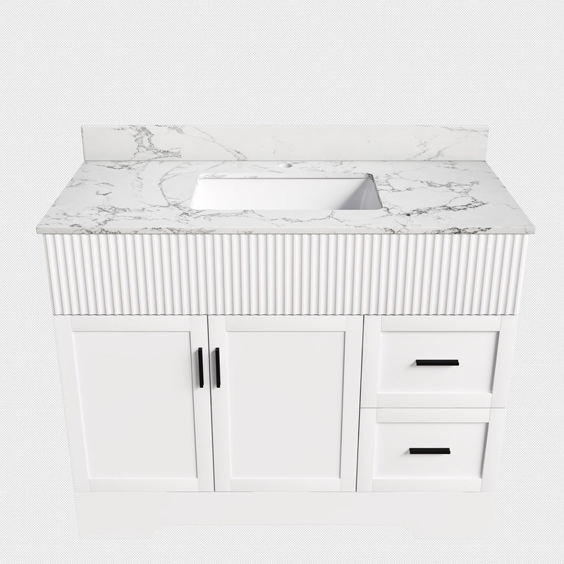 White bathroom vanity cabinet with fluted front, sink, two doors and two drawers