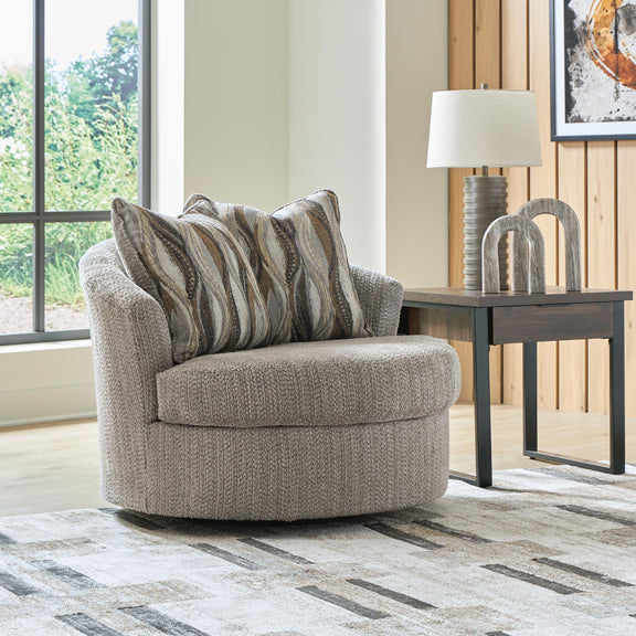 Swivel accent chair with gray textured upholstery and striped lumbar pillows