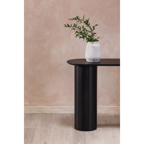 Black acacia console table with oval top and fluted pedestal legs