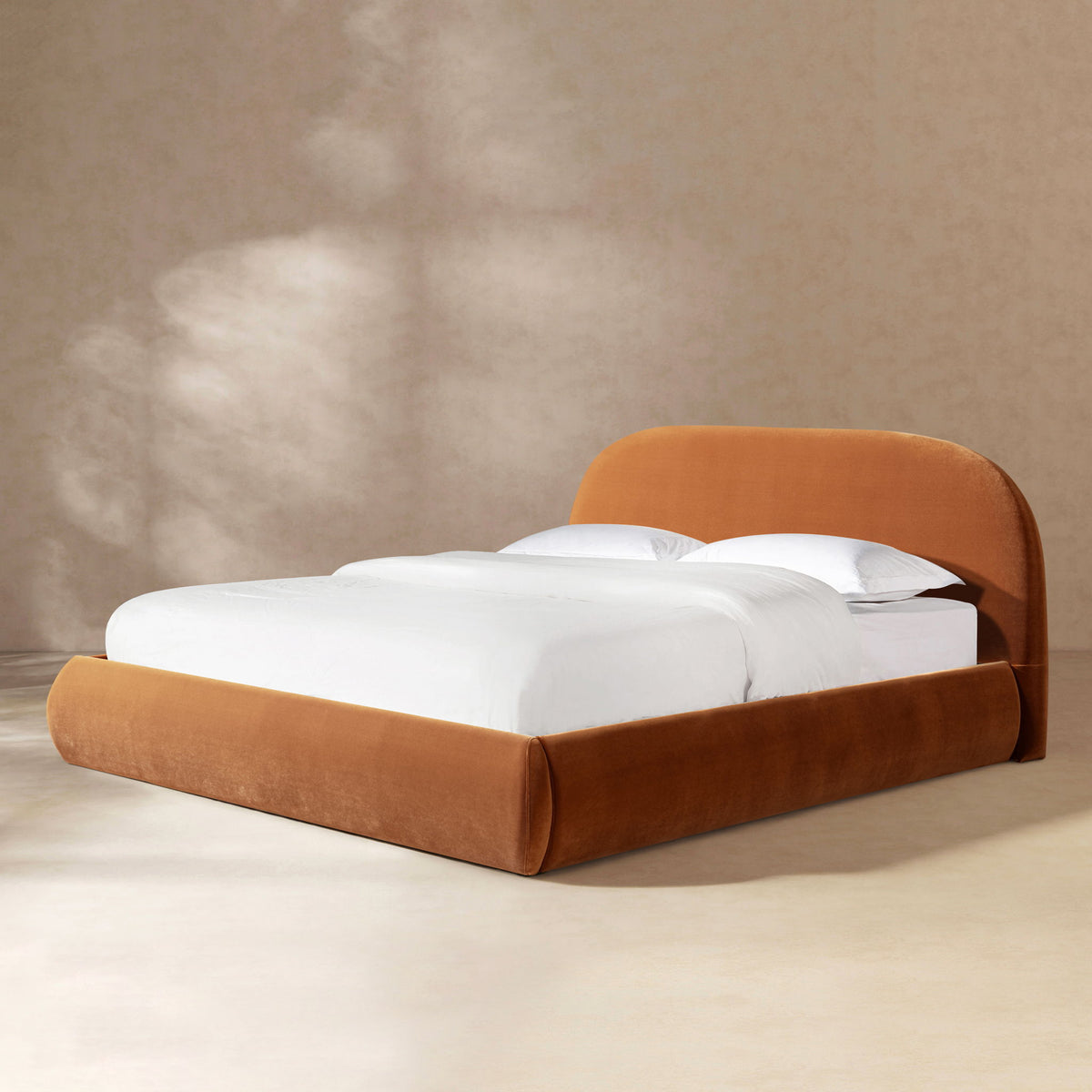 Orange upholstered platform bed with rounded headboard and thick padded rails
