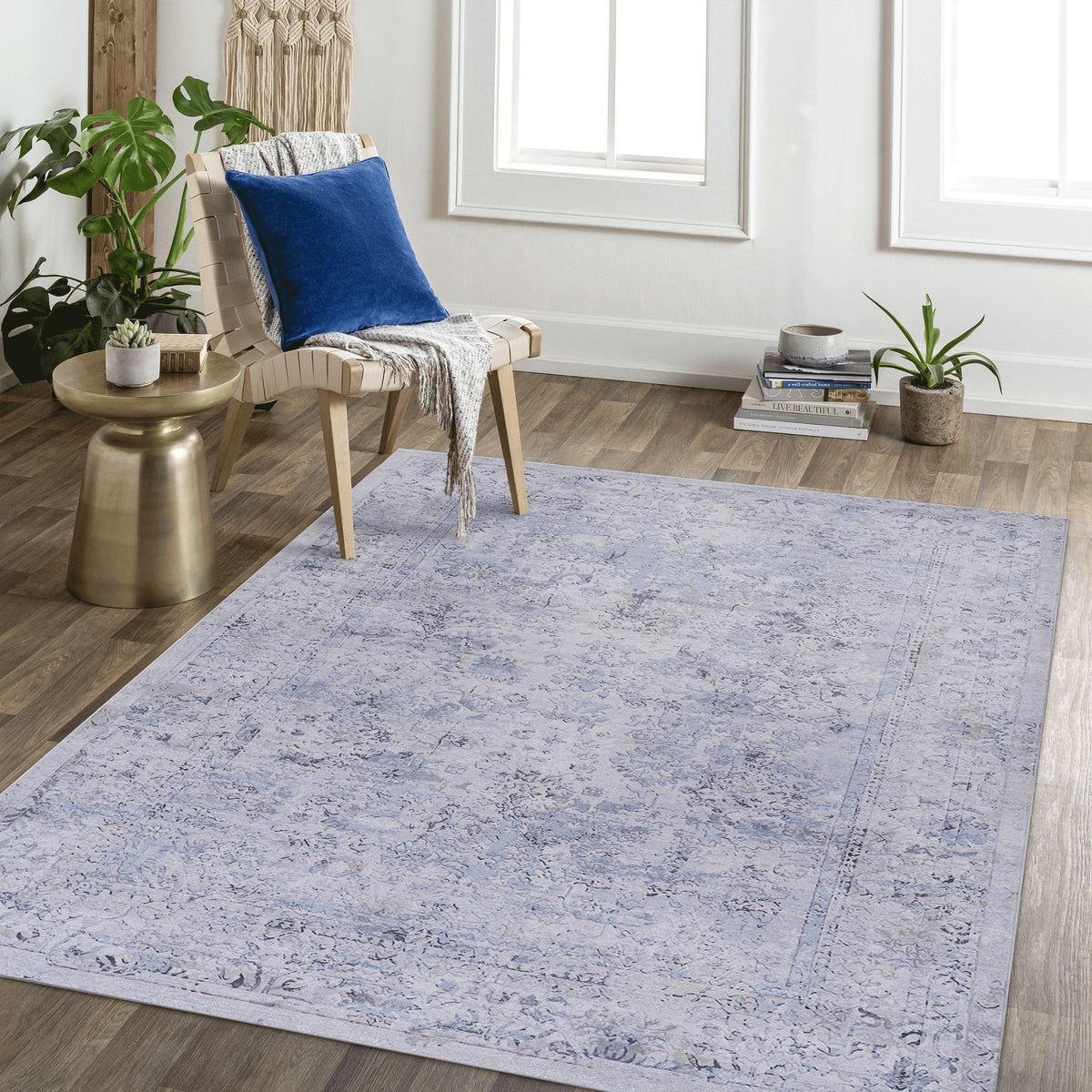Washable area rug in light blue with abstract distressed pattern and cream accents