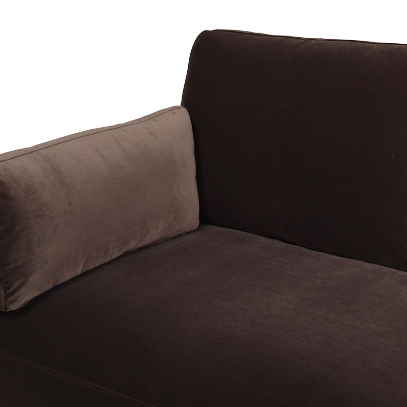 Dark brown sofa corner with plush seat cushion and matching throw pillow.