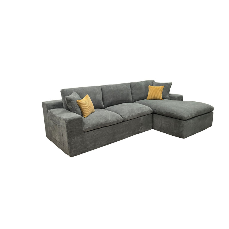 Dark gray sectional sofa with chaise, featuring two mustard accent throw pillows
