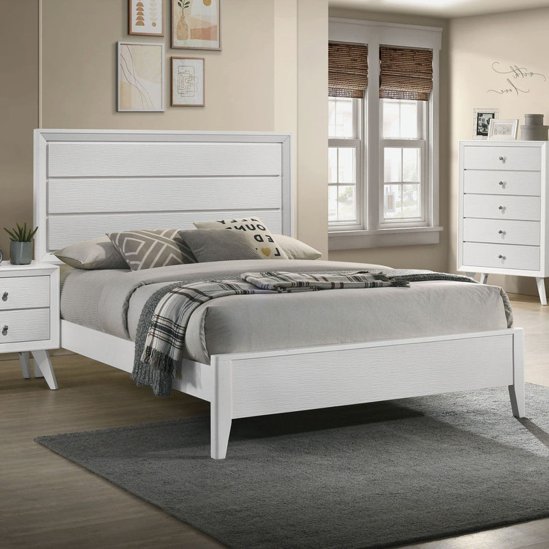 White bed with vertical panel headboard, slatted support, and angled legs