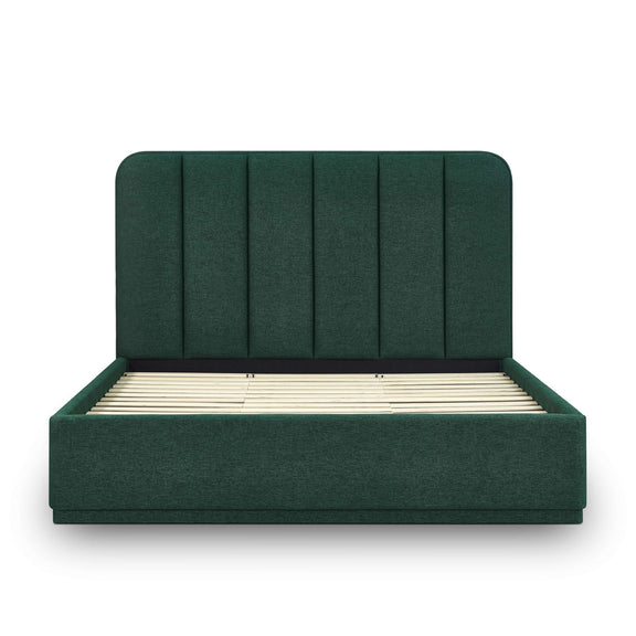 Dark green upholstered bed frame with slatted base and tufted vertical headboard.