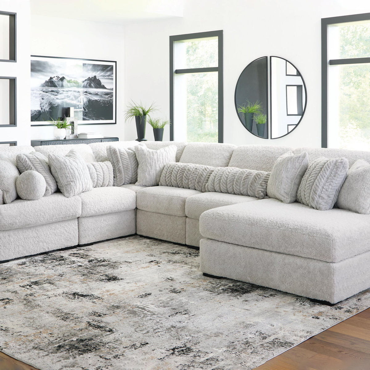 White plush sectional sofa with chaise corner, rounded headrests, and deep seats