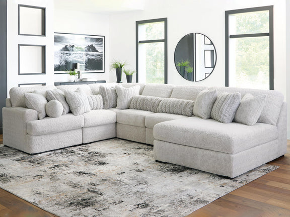 White plush sectional sofa with chaise corner, rounded headrests, and deep seats