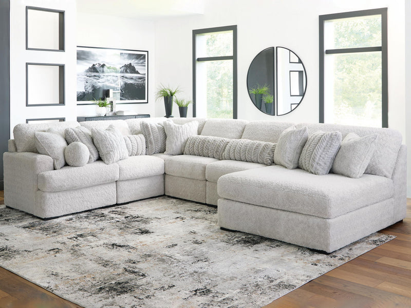 White plush sectional sofa with chaise corner, rounded headrests, and deep seats