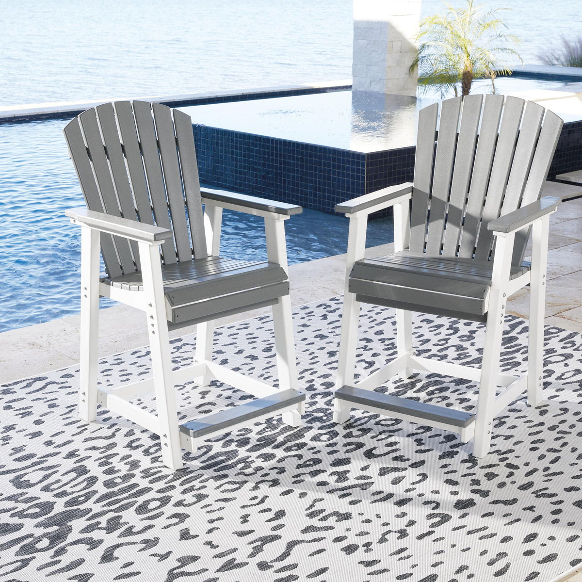 Two gray slatted barstools with white frames, armrests, and gray seat panels