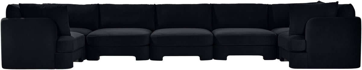 Black U-shaped sectional sofa, side view with boxy armrests and cushioned seating