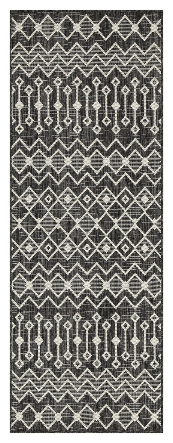Indoor/outdoor polypropylene area rug, black with white geometric zigzag and diamond pattern.