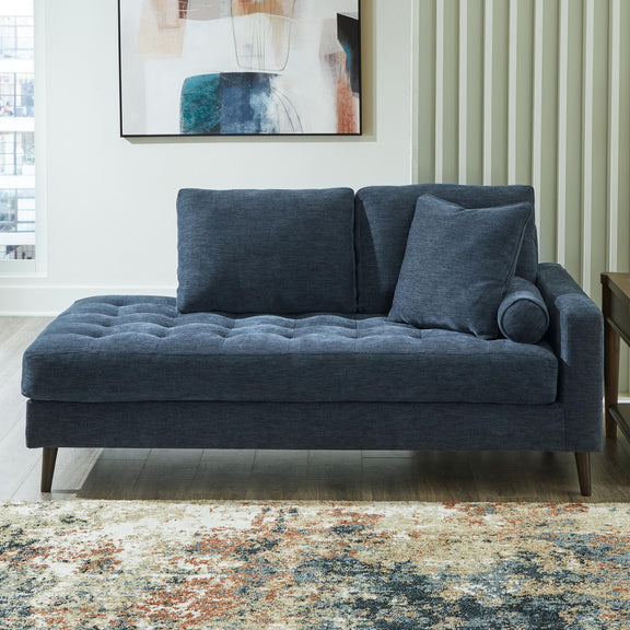 Dark blue upholstered corner chaise sofa with rounded arm and plush back cushions