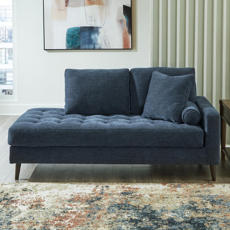 Dark blue upholstered corner chaise sofa with rounded arm and plush back cushions