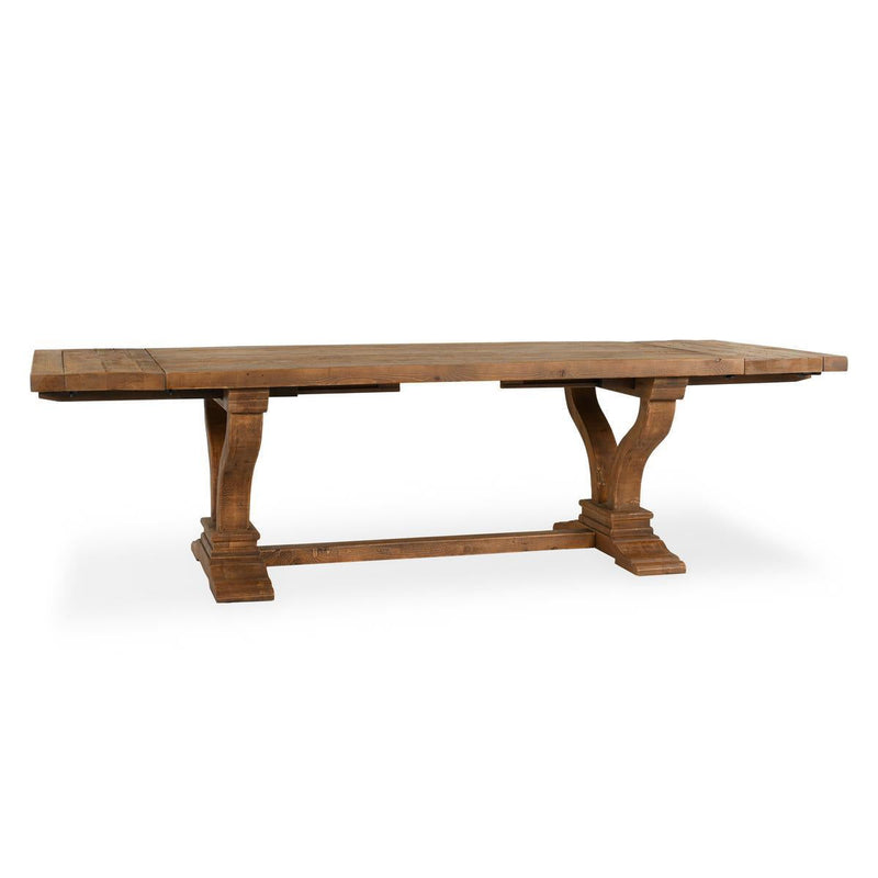 Dark brown extension dining table with carved trestle legs and long tabletop