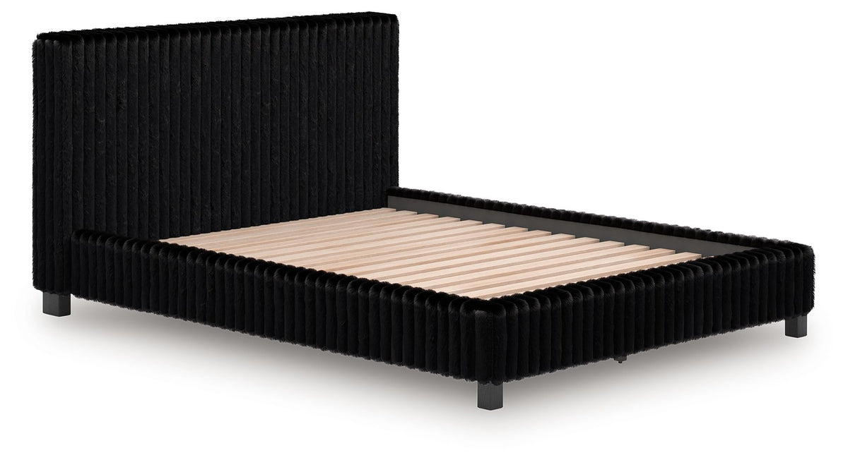 Black upholstered bed frame with vertical ribbed headboard and beige mattress