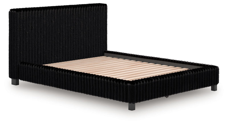 Black upholstered bed frame with vertical ribbed headboard and beige mattress