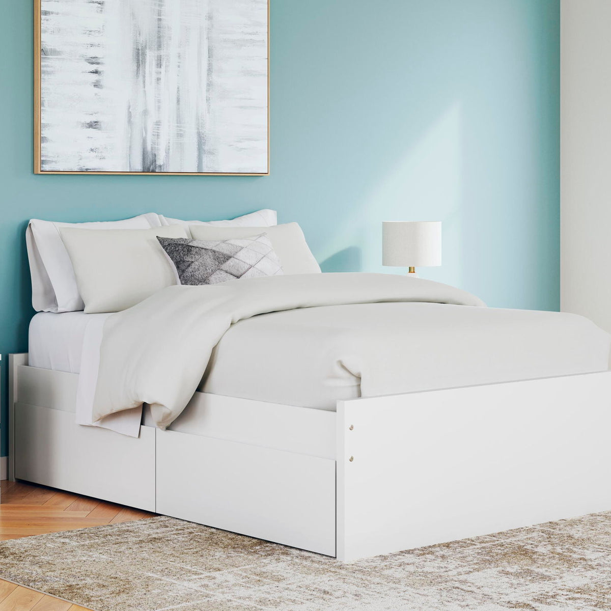 White platform bed with one side storage drawer and layered white bedding