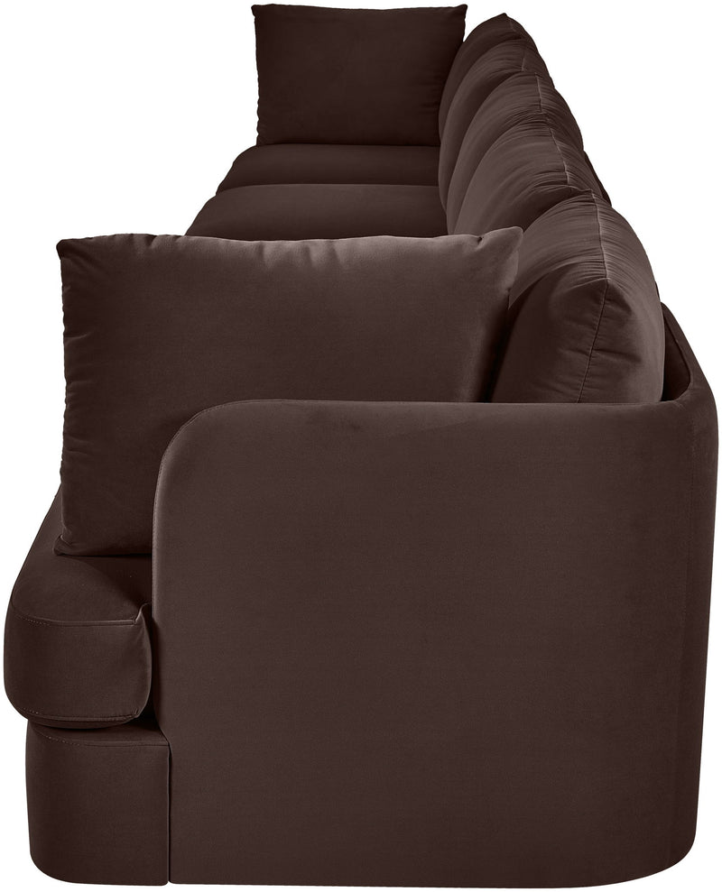 Dark brown velvet upholstered accent sofa chair with rounded arms and back pillows