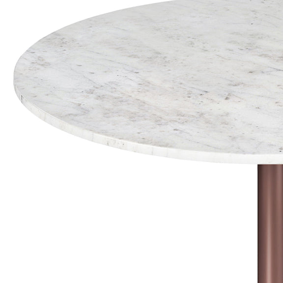 Close-up of the round table's white veined top and copper-tone pedestal