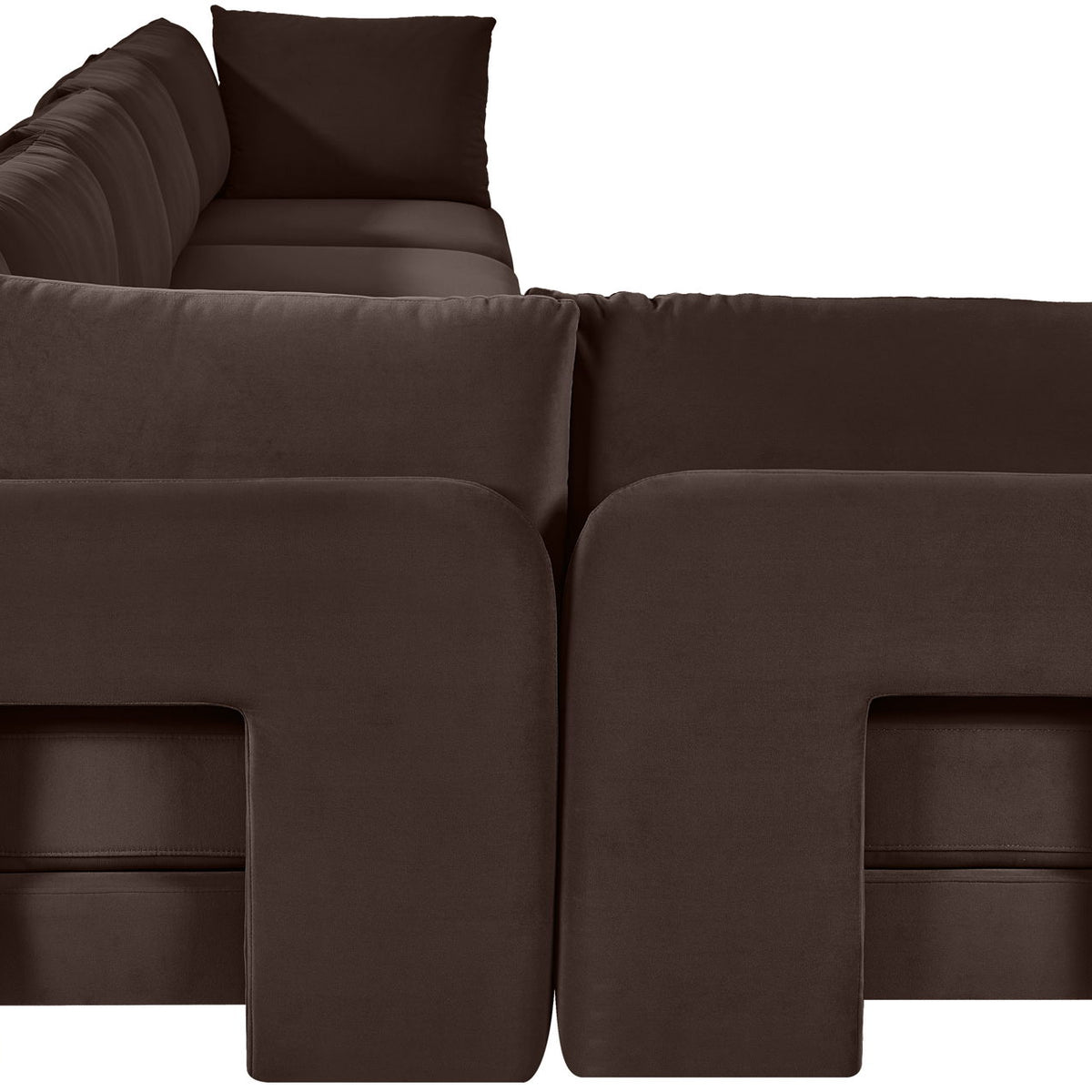Dark brown velvet L-shaped sectional sofa close-up of square armrests and seat cushions.