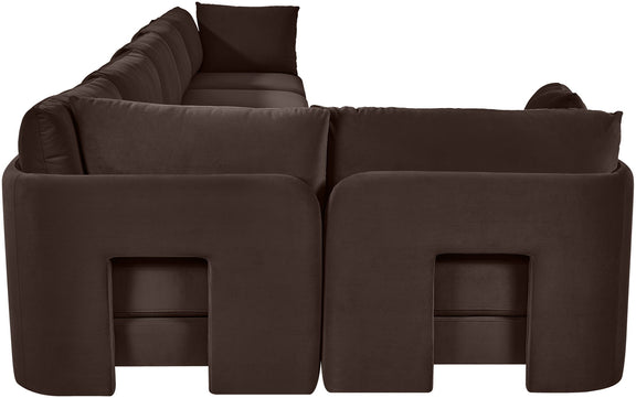 Dark brown velvet L-shaped sectional sofa close-up of square armrests and seat cushions.