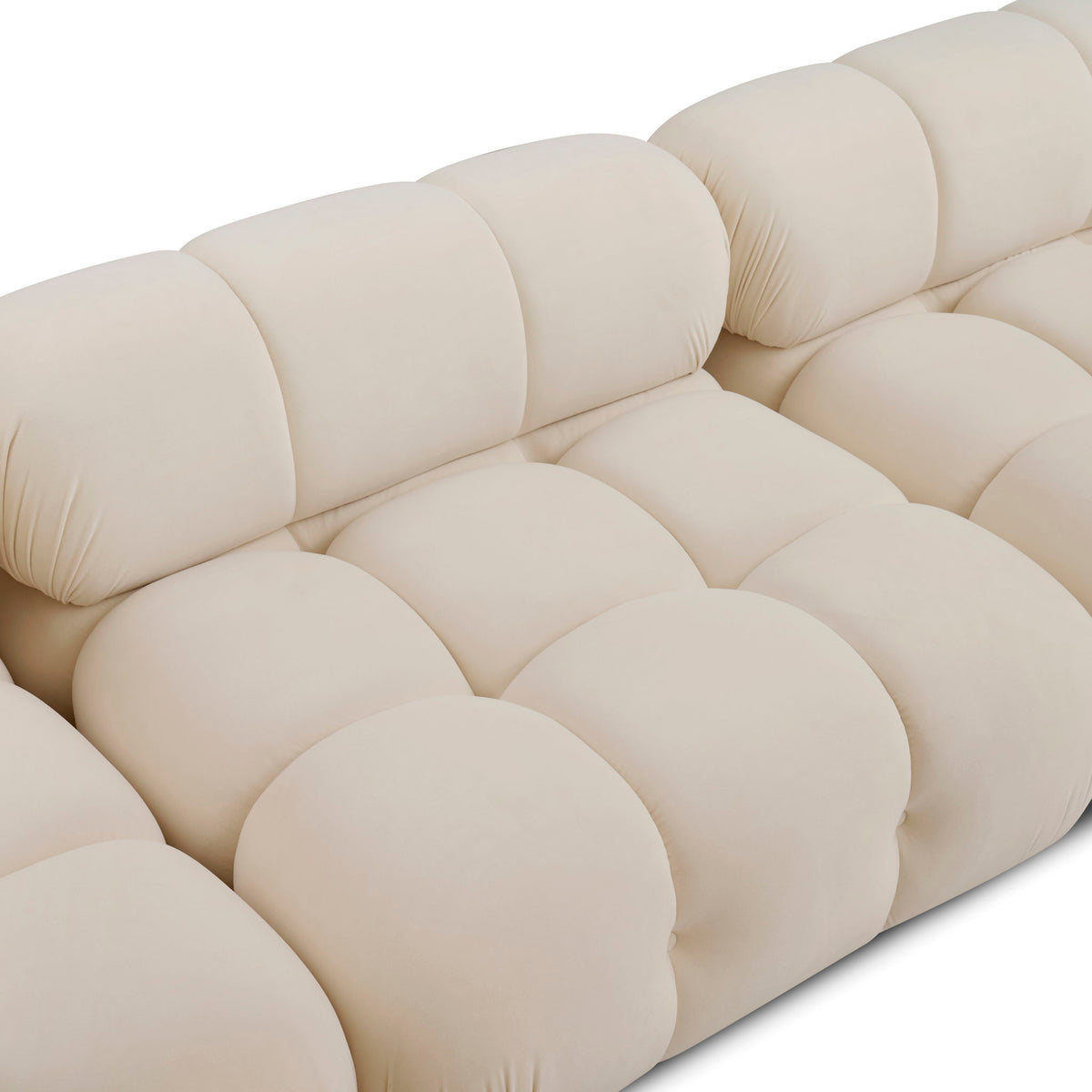 Light beige modular sectional sofa with plush padded cushions and rounded arms