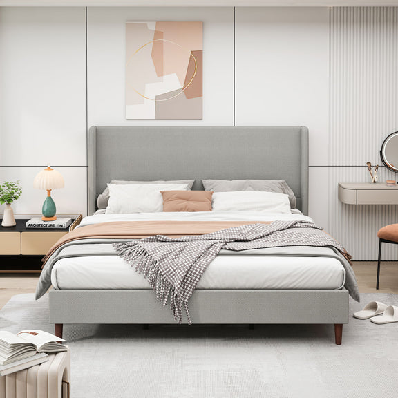 Upholstered bed with tall gray headboard and gray fabric frame