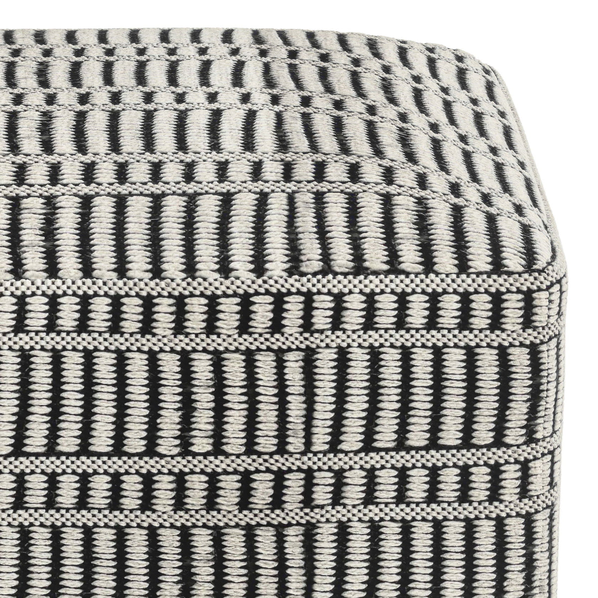 Close-up of the pouf's textured black and white woven pattern