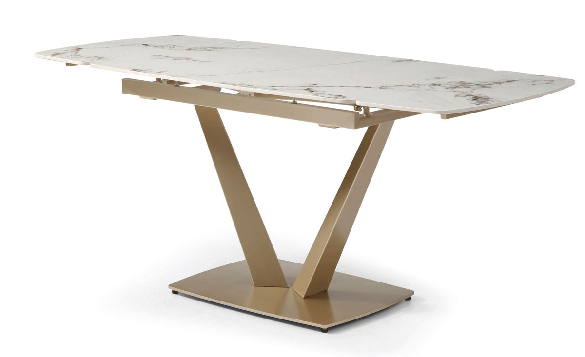 Dining table with white marble-look top and gold geometric pedestal base