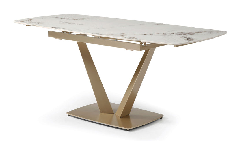 Dining table with white marble-look top and gold geometric pedestal base