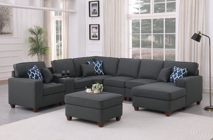 Gray sectional sofa with ottoman and blue patterned throw pillows, corner chaise style
