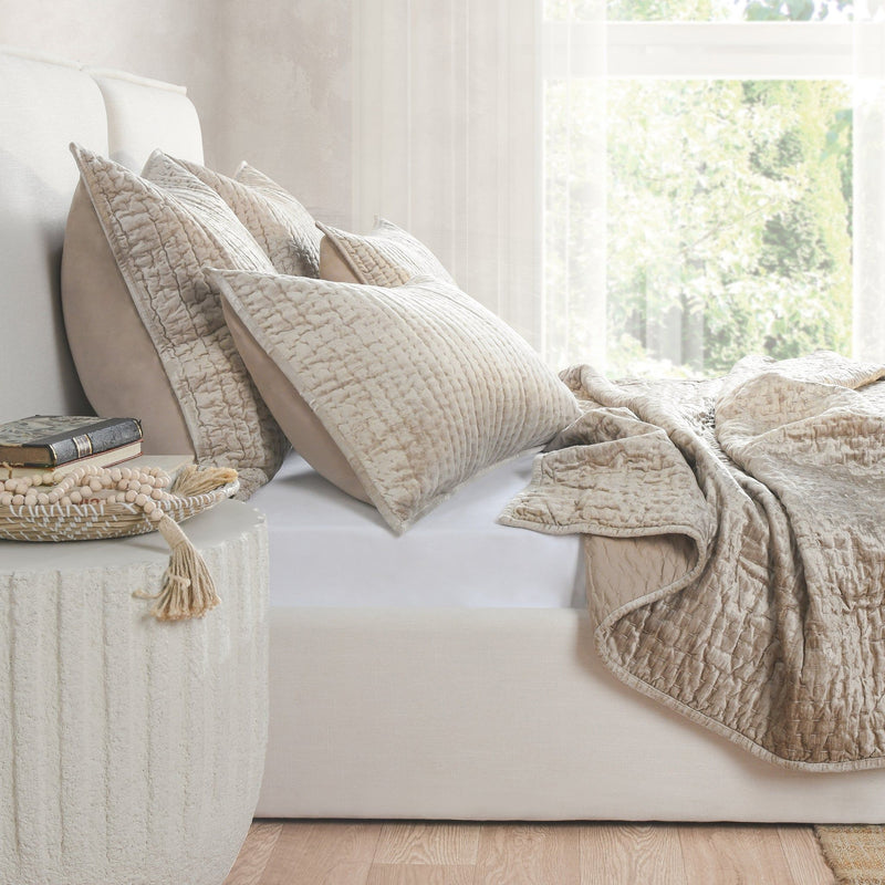 Velvet quilt set in light cream with quilted pillows and folded throw